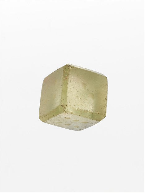A Roman glass die from the 1st–2nd century CE, the kind of dice used to play ludus duodecim scriptorum (XII scripta). The Metropolitan Museum of Art.
