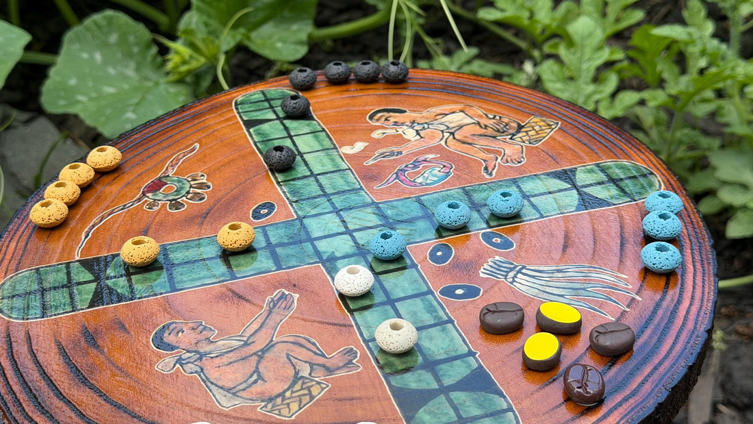 Handcrafted Patolli board — a live-edge wood slice with a UV-printed cross-shaped Aztec race track and colored stone markers, made in-house at Ancient.Games.